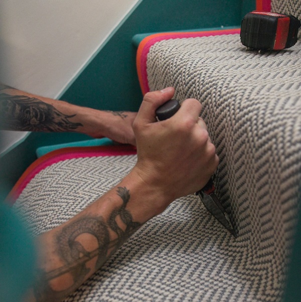 Stair runners being fitted by Sam Knott